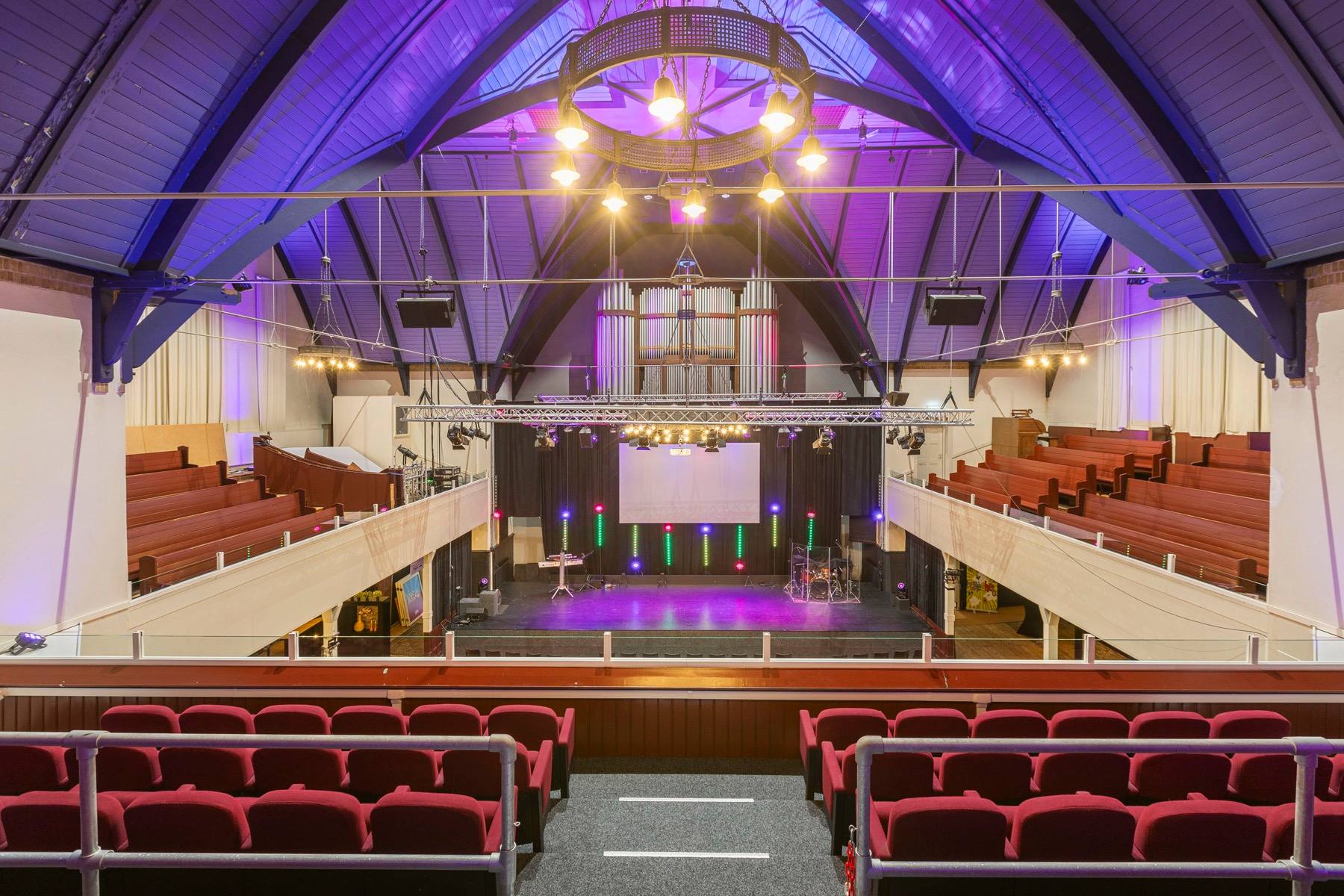 The Zuiderkerk hall lit for an event, with the organ and gallery seating at the far end.