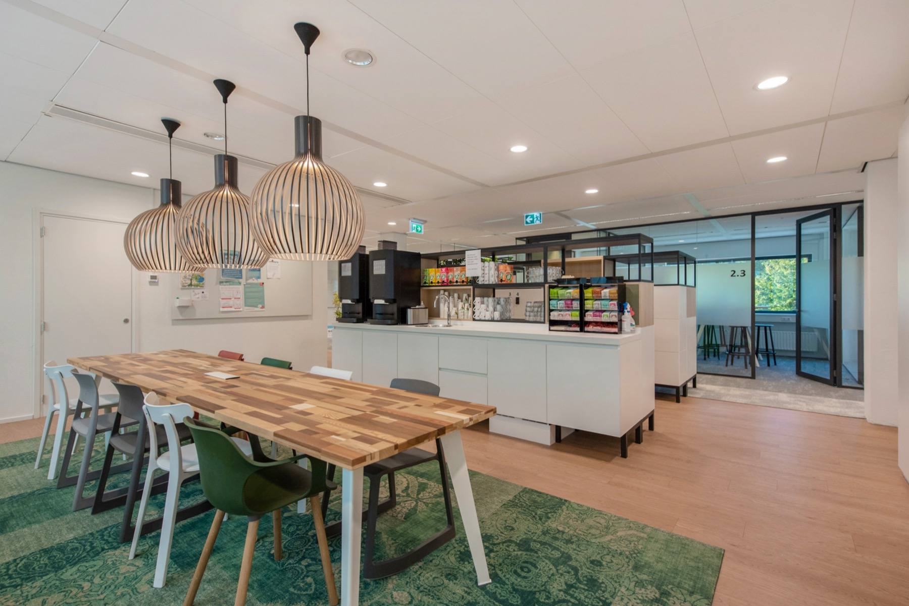 The building's café area, with a long timber table and a coffee counter.